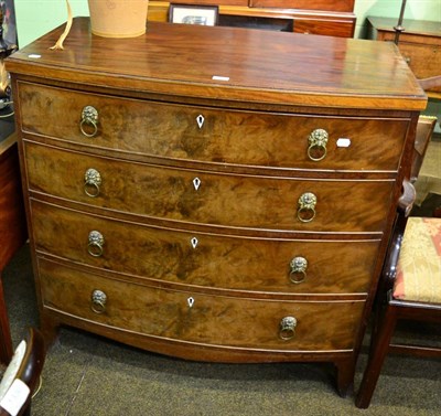 Lot 1387 - A 19th century mahogany bow front four height chest of drawers with lion mask drop-ring handles