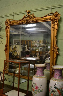 Lot 1392 - A large gilt painted over mantel mirror decorated with rocaille ornament