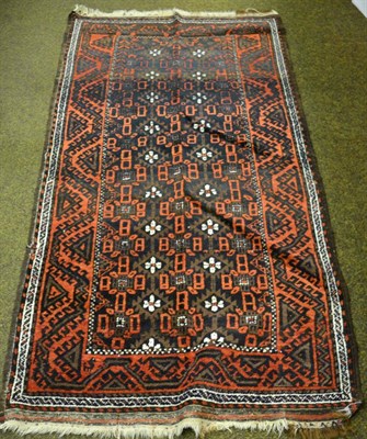 Lot 1404 - Balouch rug, Khorasan, circa 1900, the midnight blue field with columns of stylised flowerheads...