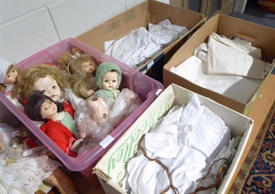 Lot 1410 - Assorted dolls including modern bisque examples, a quantity of dolls clothing, white cotton...