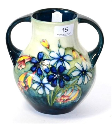 Lot 15 - A William/Walter Moorcroft spring flowers pattern twin handled vase, impressed factory marks...
