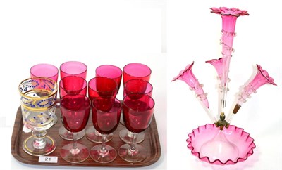 Lot 21 - A Victorian cranberry glass epergne (one arm lacking), together with ten cranberry wines of similar