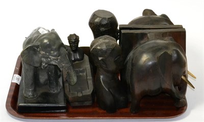 Lot 30 - A tray of carved ebony figures, bookends, ashtrays etc