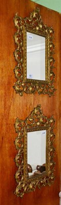 Lot 49 - A pair of brass decorative mirrors