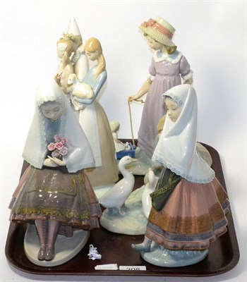 Lot 208 - Six Lladro figures comprising girl holding roses, girls holding a lamb, lady with geese, lady...