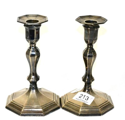 Lot 213 - A pair of Georgian style silver baluster candlesticks, by Hawkesworth, Eyre and Co Ltd....