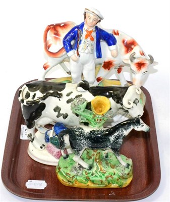 Lot 217 - A 19th century cow creamer, Staffordshire figure group and Staffordshire spill vase