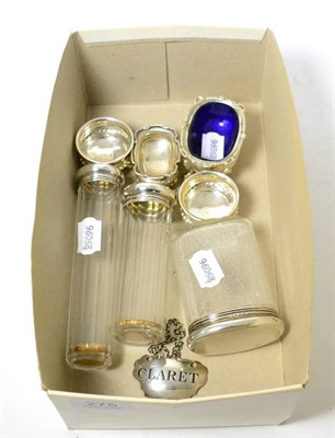 Lot 275 - A wine label, three silver mounted dressing table bottles and four silver salts