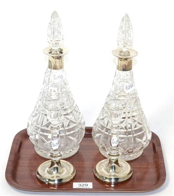 Lot 329 - A pair of silver collared decanters by Mappin & Webb together with a pair of modern filled...