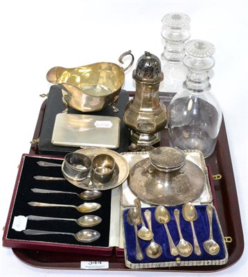 Lot 344 - A group of silver including a sauce boat, a cigarette box, a dish, two napkin rings, a capstan...