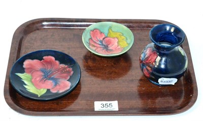 Lot 355 - Two Moorcroft dishes and a small Moorcroft vase, each decorated in the Hibiscus pattern