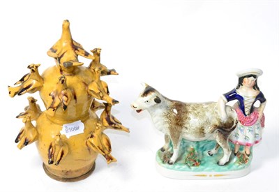 Lot 358 - A 19th century Staffordshire pottery cow group and folk pottery bird money box