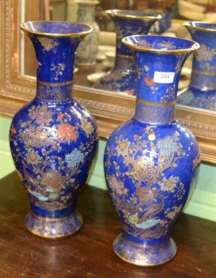 Lot 394 - A matched pair of Carlton Ware lustre vases, each in the birds of paradise pattern