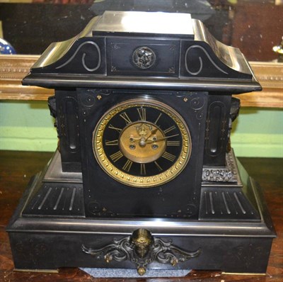 Lot 396 - A black slate striking mantel clock