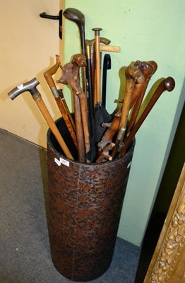 Lot 397 - A quantity of sticks, canes and parasols including dog carved handles, etc (in a stick stand)