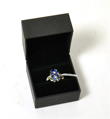 Lot 400 - An 18ct gold sapphire and diamond flower cluster ring, finger size R1/2