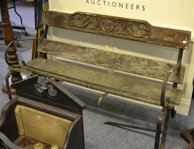 Lot 1119 - A wrought iron framed garden bench