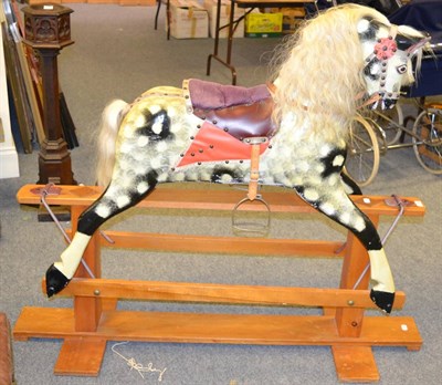 Lot 1122 - A painted wooden rocking horse on a trestle base