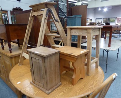 Lot 1140 - A set of pine decorator's steps, two pine stools, and a small cabinet