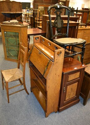 Lot 1153 - An Arts & Crafts oak hall bureau, together with two rush seated chairs