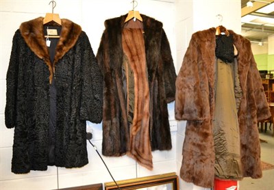 Lot 1171 - Astracan fur coat with mink collar and matching hat, musquash coat, another and a stole