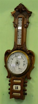 Lot 1231 - An oak aneroid barometer with combined calendar displays