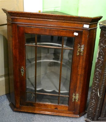 Lot 1240 - A 19th century glazed oak hanging corner cupboard