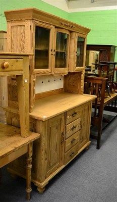 Lot 1246 - A pine kitchen dresser, the glazed upper section with bow fronted central door, flanked by a...