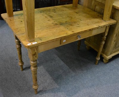 Lot 1248 - A pine farmhouse kitchen table with a drop leaf and fitted with a drawer