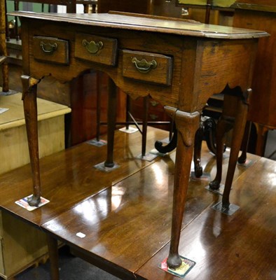 Lot 1250 - An 18th century oak three drawer lowboy