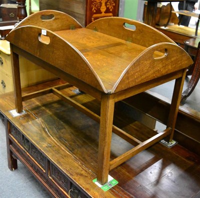 Lot 1254 - An oak butlers tray on stand with four drop sides