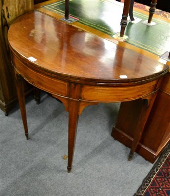 Lot 1267 - A Georgian mahogany demi lune fold over tea table