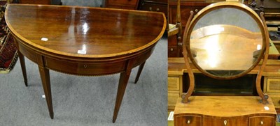 Lot 1282 - An inlaid mahogany demi lune fold over tea table, together with a 19th century mahogany toilet...