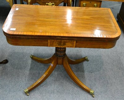 Lot 1285 - A cross banded mahogany fold over card table