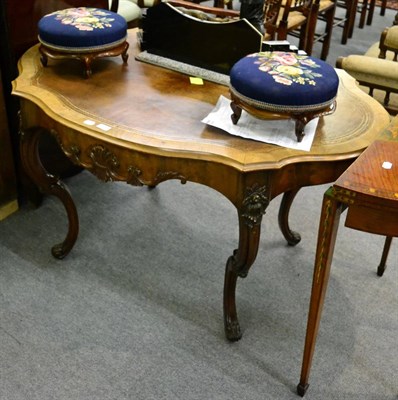 Lot 1290 - A 19th century style leather inset shaped oval writing table raised on carved c scroll legs