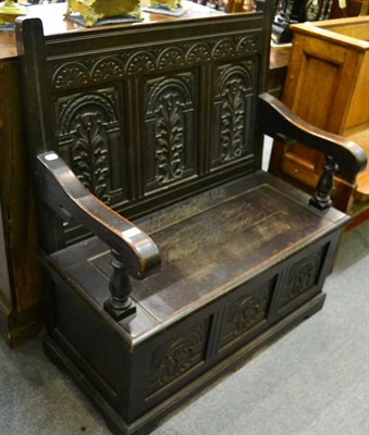 Lot 1292 - A carved oak monks bench