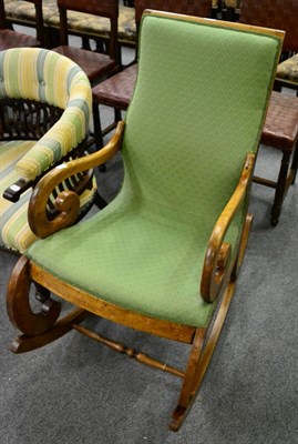 Lot 1306 - A 19th century mahogany rocking chair with scroll arms and legs