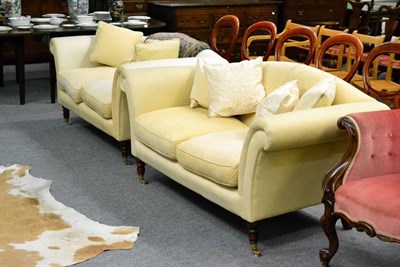 Lot 1312 - A pair of cream upholstered sofas