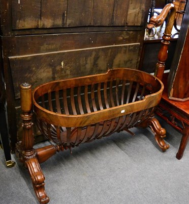 Lot 1338 - A Victorian carved mahogany cradle with carved swans head and neck upright, and banded basket...