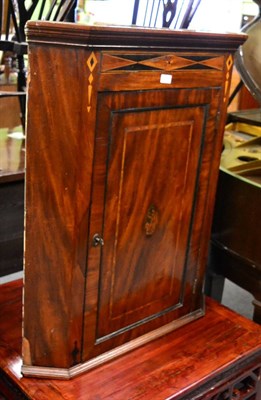 Lot 1339 - A mahogany inlaid early 19th century corner cupboard