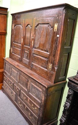 Lot 1355 - A late 18th century enclosed oak dresser