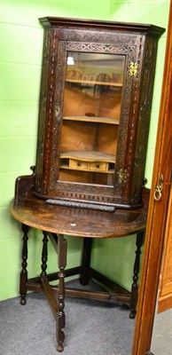 Lot 1358 - An 19th century carved oak glazed hanging corner cupboard together with a lunette carved oak...