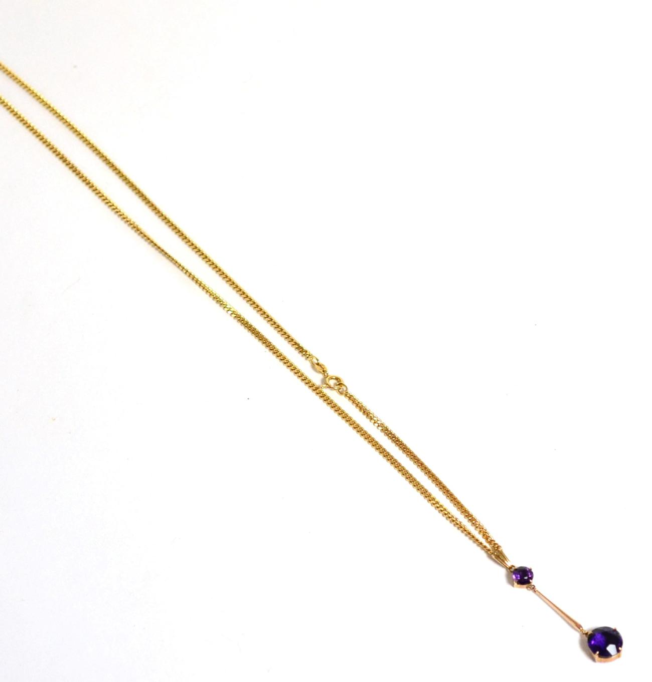Lot 13 - An amethyst necklace, a round cut amethyst suspends a larger round cut amethyst by a yellow...