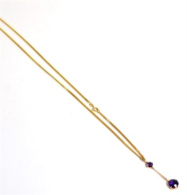 Lot 13 - An amethyst necklace, a round cut amethyst suspends a larger round cut amethyst by a yellow...