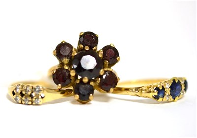 Lot 18 - An 18ct gold sapphire and diamond ring, a garnet set flower ring stamped '375' and a diamond...