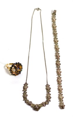 Lot 52 - A sapphire and multi gemstone cluster ring and a marcasite necklace and bracelet set (3)