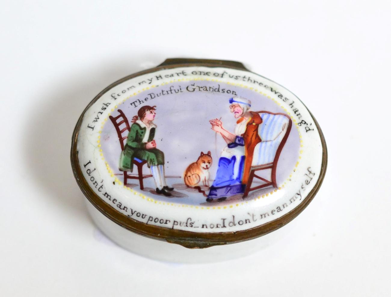 Lot 61 - An oval enamel patch box depicting seated figures and a cat, circa 1800