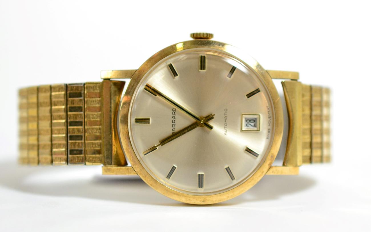 Lot 69 - A 9ct gold automatic centre seconds calendar wristwatch, signed Garrard, case back with inscription