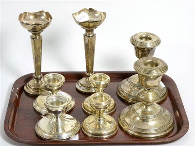 Lot 93 - A pair of silver posy vases; a pair of silver candlesticks and two pairs of silver dwarf...