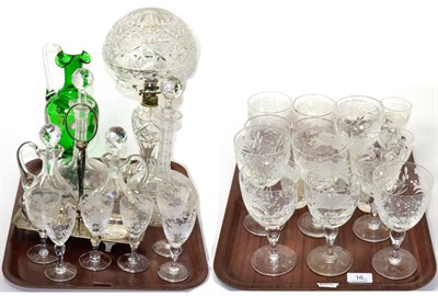 Lot 16 - A quantity of engraved wine glasses, tumblers, two decanters, green glass ewer and a cut glass...